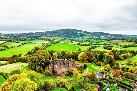 Autumn Colours over ruins of Grosmont Castle from a drone, Grosmont, Monmouthshire, Wales, UK