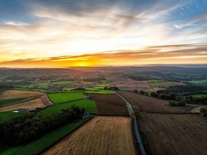 Sunset of Devon Farms and Fields over Berry Pomeroy from a drone, Totnes, England, United Kingdom