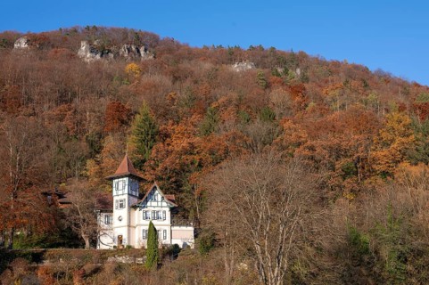 Historic villa in mixed autumn forest in Franconian Switzerland, Muggendorf, Upper Franconia,