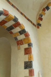 Painted arch in red, yellow and black. St Aignan's Church of Begues. Allier department. Auvergne