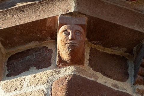 Azerat village. Sculpture of Roman church Saint-Jean-Baptiste . Haute Loire. Auvergne Rhone Alpes.