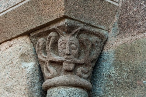 Sculptural details on the porch of the Romanesque church in Azerat village, Haute Loire,