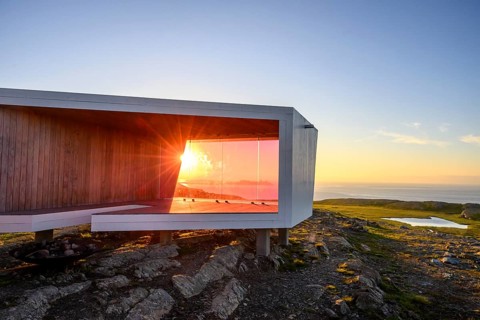 Modern building with glass wall in front of sunset on Mount Domen, sea view, nestled in rocky