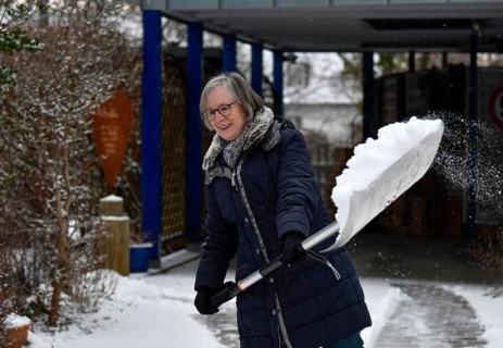 Elderly woman sweeping week with snow shovel, snow shovel, snow remover, shovel, clear, shovel