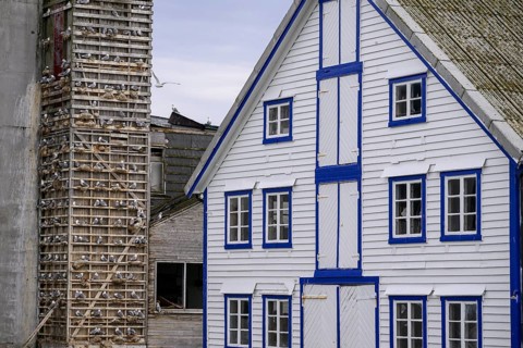 A traditional building with blue and white accents and a striking façade is seen next to an