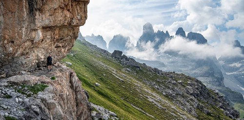 Mountaineers on a trail in front of picturesque mountain landscape with rocky peaks, Via Ferrata