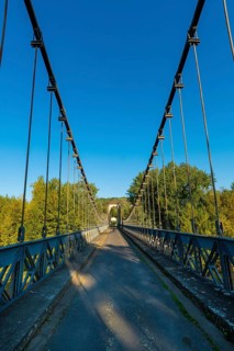 Suspension bridge of Coudes village on river Allier. Puy de Dome. Auvergne Rhone Alpes. France