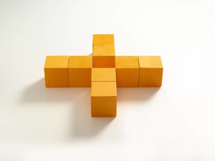 8 yellow wooden cubes against a white background