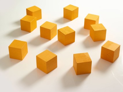 11 yellow wooden cubes against a white background