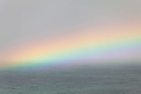 Tallow Beach bay with rainbow, lookout Byron Bay lighthouse, New South Wales, Australia