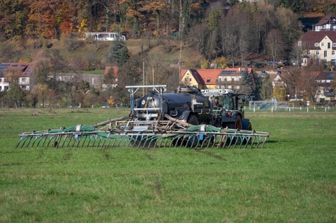 Farmer fertilizing his meadows by tow hose, Eschenbach, Middle Franconia, Bavaria, Germany