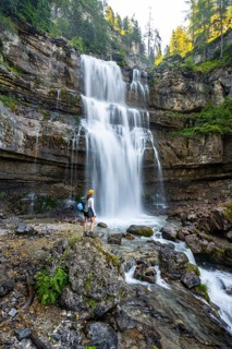 Young woman in front of Cascata di Mezzo waterfall, long exposure, Vallesinella, Brenta, Trentino,