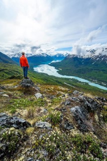 Climber enjoying the view, Slaughter Ridge Trail, view of snowy mountains and turquoise blue Kenai
