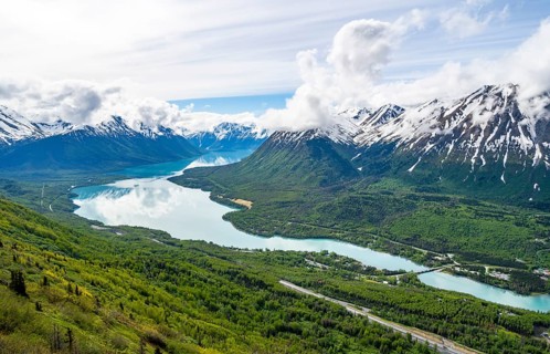 View of snowy mountains in spring and turquoise blue Kenai Lake, Slaughter Ridge Trail, Cooper