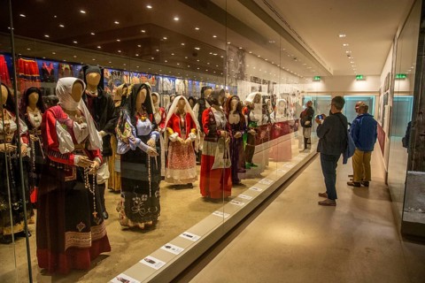 Sardinian folk costumes and visitors in the museum in Nuoro, Sardinia, Italy