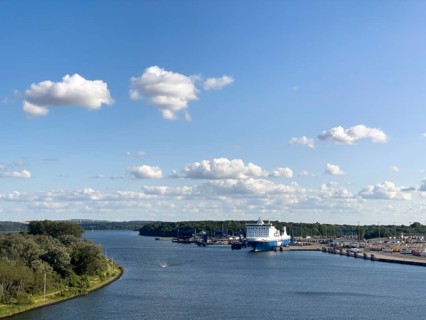 Scandinavienkai Tavemünde with large Finnlines ferry in port, surrounded by water and fluffy