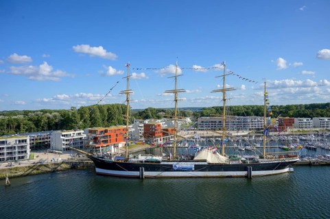 Harbour view with the legendary four-masted PASSAT barque and many boats in front of modern