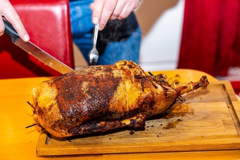 Grilled Christmas goose is expertly carved. Münsingen, Baden-Württemberg, Germany