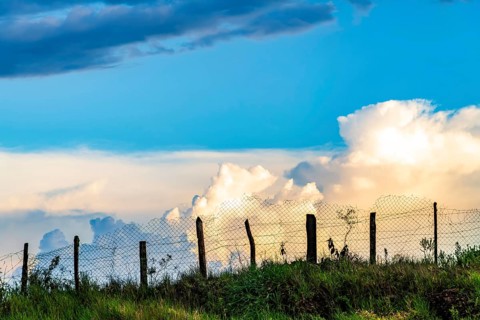 Wire fence on top of the hill during sunset on the farm, Ouro Preto, Minas Gerais, Brazil