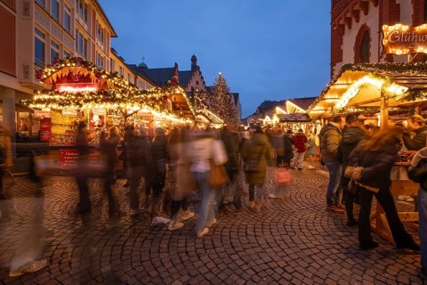 December 22, 2025, Frankfurt Christmas Market on Roemerberg at twilight. Traditional wooden stalls