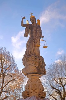 Justice as an angel and golden crown with cross, and beam scale, golden wings, symbol of justice