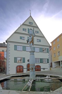 Amtshaus with fountain and Neptune sculpture, Roman water god, historic half-timbered house,
