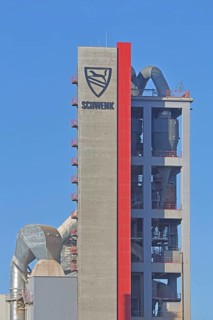 Silo with inscription and emblem of Zementfabrik Schwenk Manufacture of cement, tower with pipes,