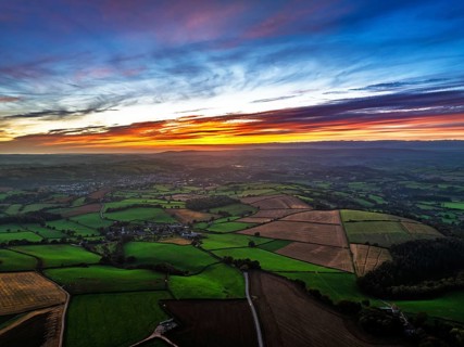 Sunset of Devon Farms and Fields over Berry Pomeroy from a drone, Totnes, England, United Kingdom