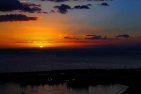 Dramatic sunset over the ocean with intense colors in the sky, Los Cristianos, Tenerife