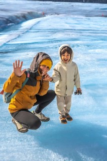 Mother and her son are enjoying their visit to the athabasca glacier in jasper national park,
