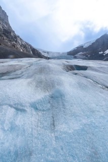 Athabasca glacier is showing signs of melting and receding, revealing the underlying terrain and