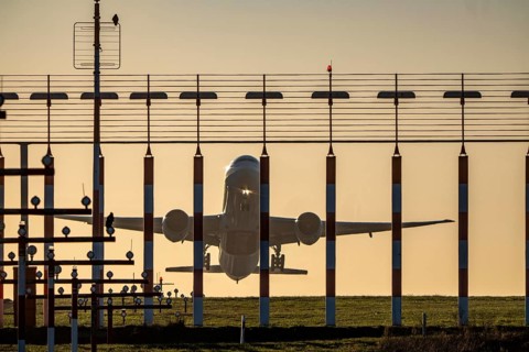 Runway lighting, approach aids, at Düsseldorf International Airport, sunset, aircraft taking off,