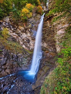 Diesbach waterfall in autumn-colored surroundings, Linthal, Klausenpass, Canton of Glarus,
