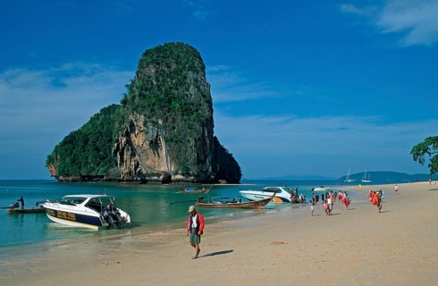 Rocks in the sea, boats and people on Pranang Cave beach, two years in front of the tsunami, Krabi,