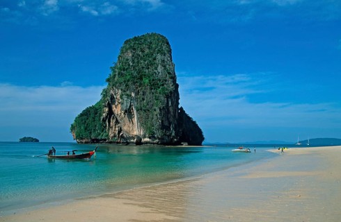Rocks in the sea and longtail boat on Pranang Cave beach, two years in front of the tsunami, Krabi,
