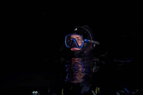 Divers at night in Lake Walen. Tauchplatz Känzeli, Mols, Canton of St. Gallen, Switzerland