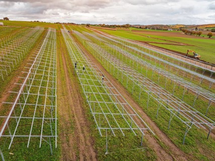 Technical structures of a solar plant under construction on wide fields, energy revolution,