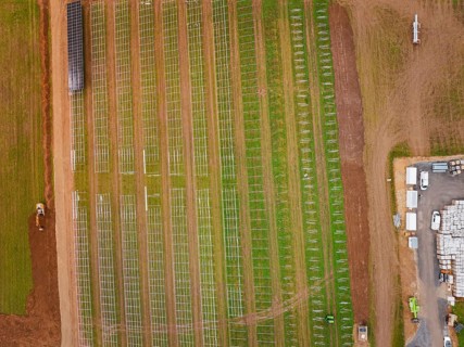 Aerial view of a construction project for solar energy with a cross-field framework, Energiewende,