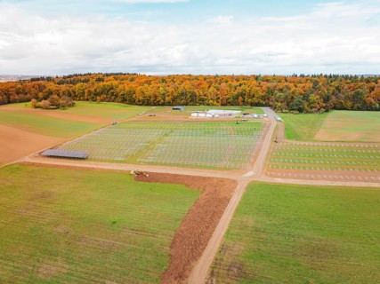 Wide landscape with fields and construction areas for solar systems near forest, energy transition,