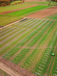 Aerial view of fields with solar frame on green fields, energy transition, construction of PV open