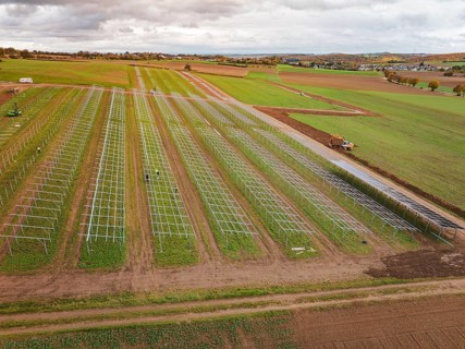 Aerial view of a solar plant under construction on extensive fields, energy transition,