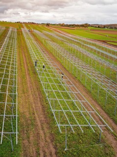 Structures of an incipient solar plant in fields in a rural area, energy transition, construction