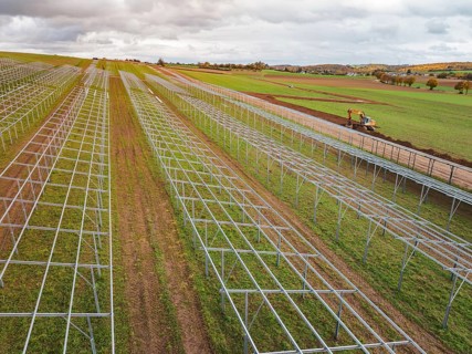 Solar system under construction in fields in a rural landscape, energy transition, construction of