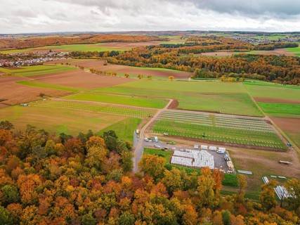 Autumn panorama with colorful foliage, fields and a small village in the distance, Energiewende,