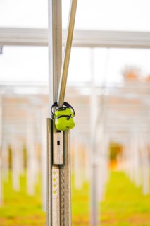 Close-up of a metal structure with headphones attached to a field, Energiewende, construction of PV