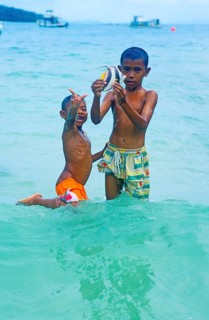 Two boys with a tropical fish on Ko Phi Phi Don, two years in front of the tsunami, Thailand,