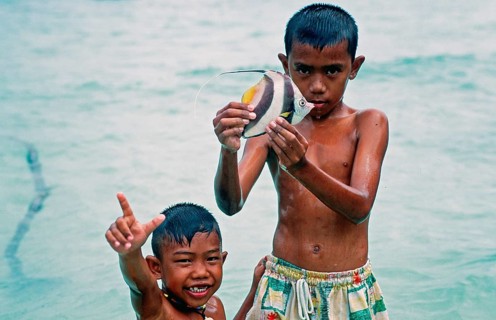 Two boys with a tropical fish on Ko Phi Phi Don, two years in front of the tsunami, Thailand,
