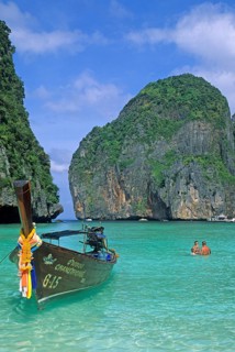 People, longtail boats on Maya Bay beach, known from the movie The Beach, one year in front of the