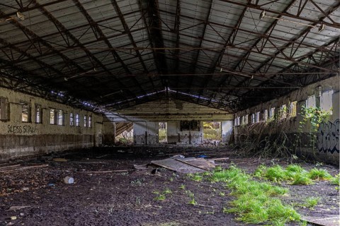 Abandoned hall with Grafity, dilapidated plant of a former agricultural production cooperative of