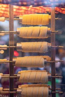 The trendy Chimney Cake stand at Stuttgart Christmas Market offers freshly baked, sweet treats. The